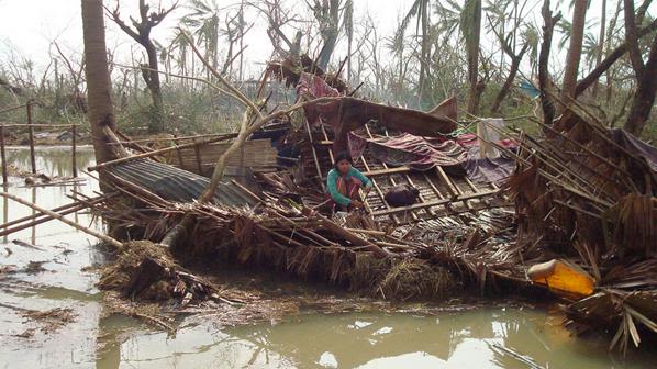 Cyclone survivors in Myanmar shelter in the ruins of their destroyed home