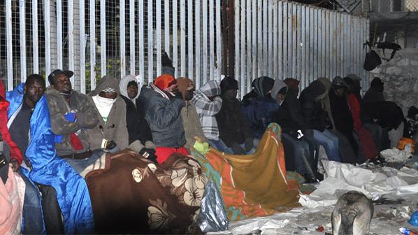 Lines of people sleep rough on Petrou Ralli Street in Athens in a queue to apply for asylum