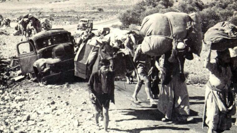 Palestinian refugees carrying their possessions, in 1948