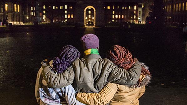 A family from the DRC now in Ireland hug while viewing the lights at night